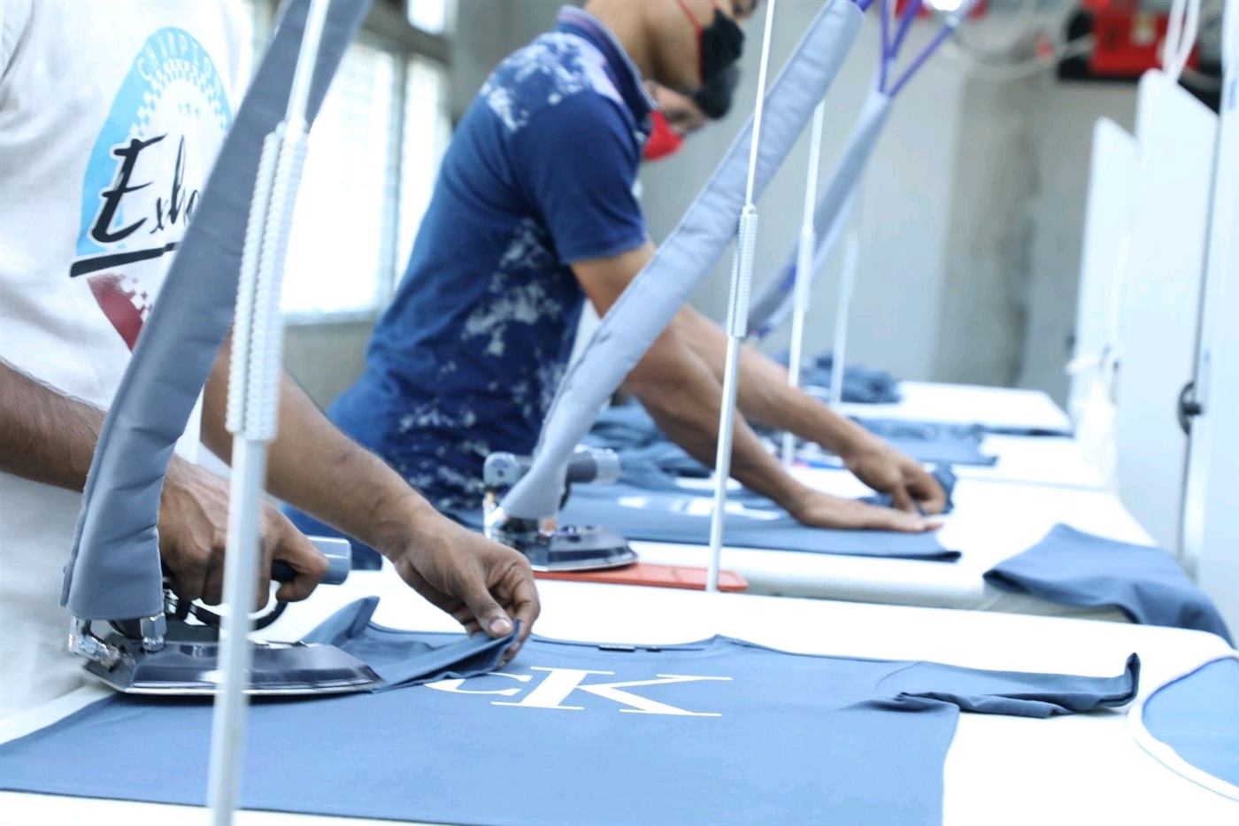 Finishing staff pressing printed knit garments