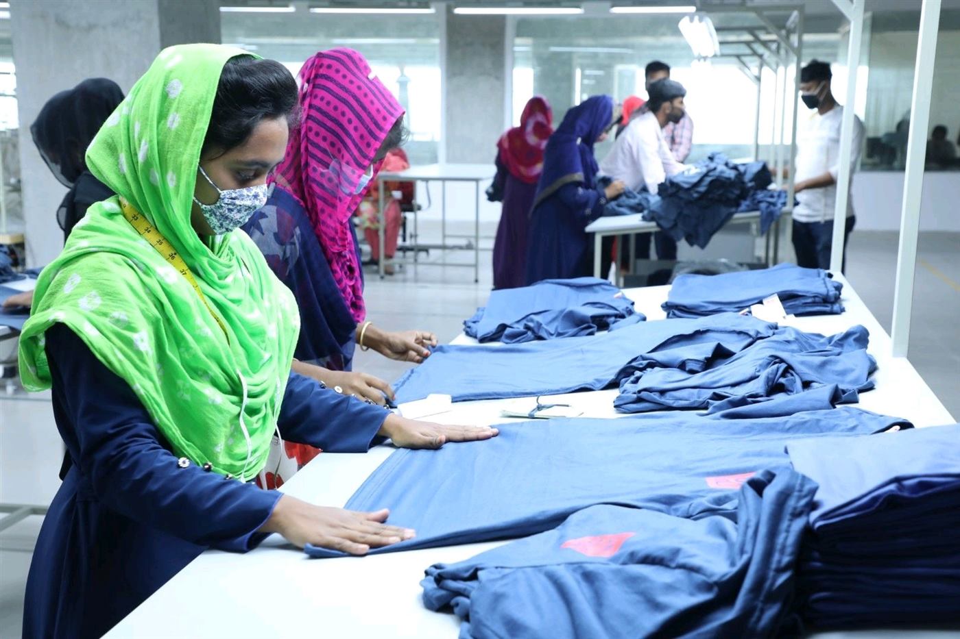 Team members inspecting and folding garments